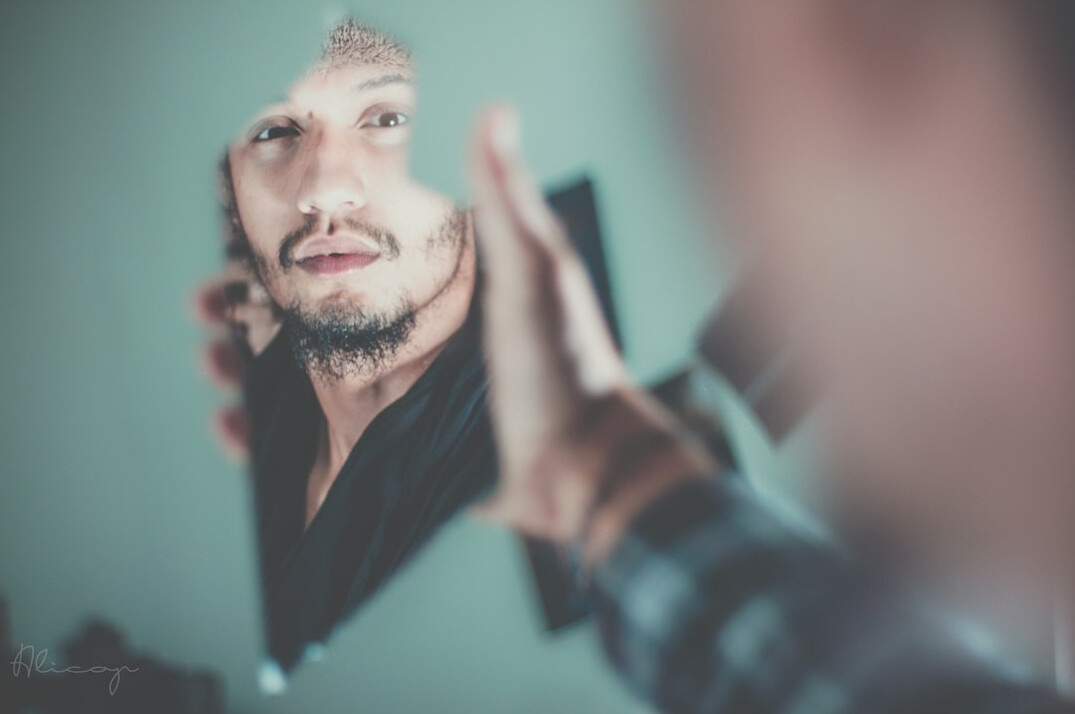 person reflecting in mirror